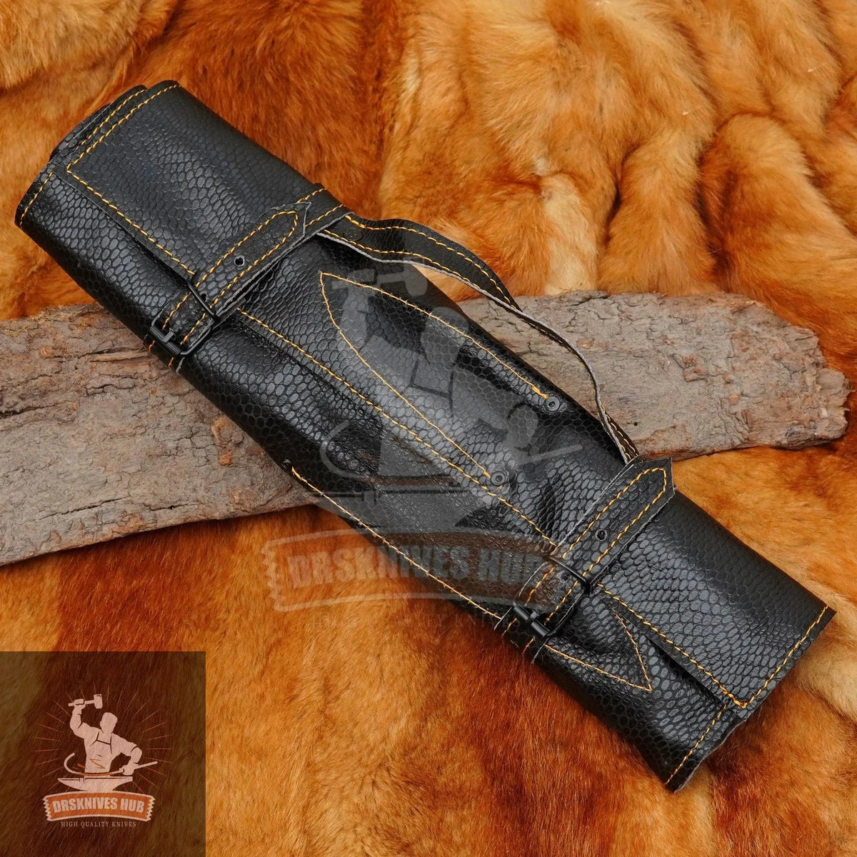 Black textured knife roll with yellow stitching on rustic wood and fur background