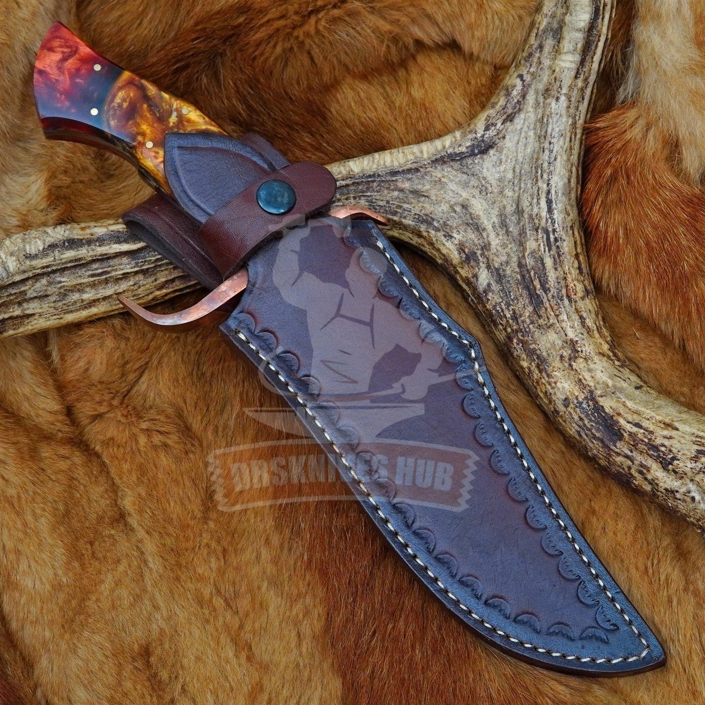 Handmade Damascus hunting knife with exotic resin handle, leather sheath, on fur and antler