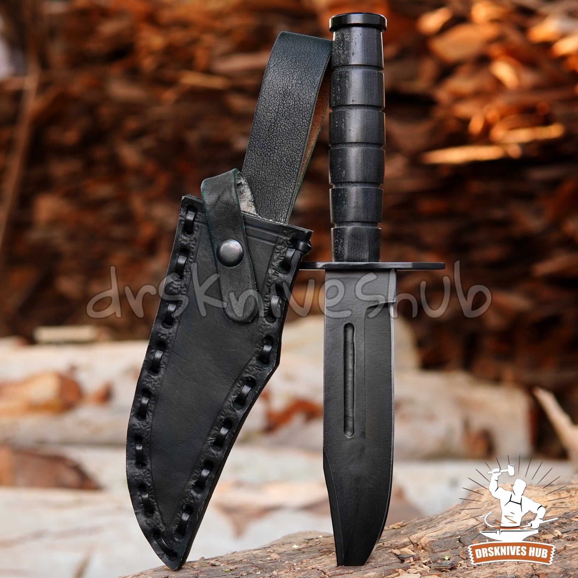 Black knife with leather sheath on a wooden surface with blurred natural background