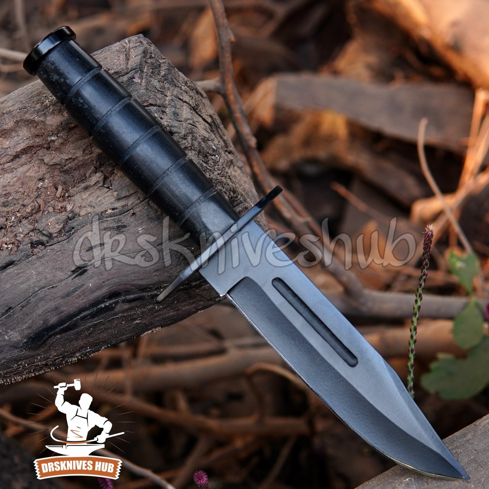 Black knife with a tactical design on a natural background, featuring the DRS Knives Hub logo.