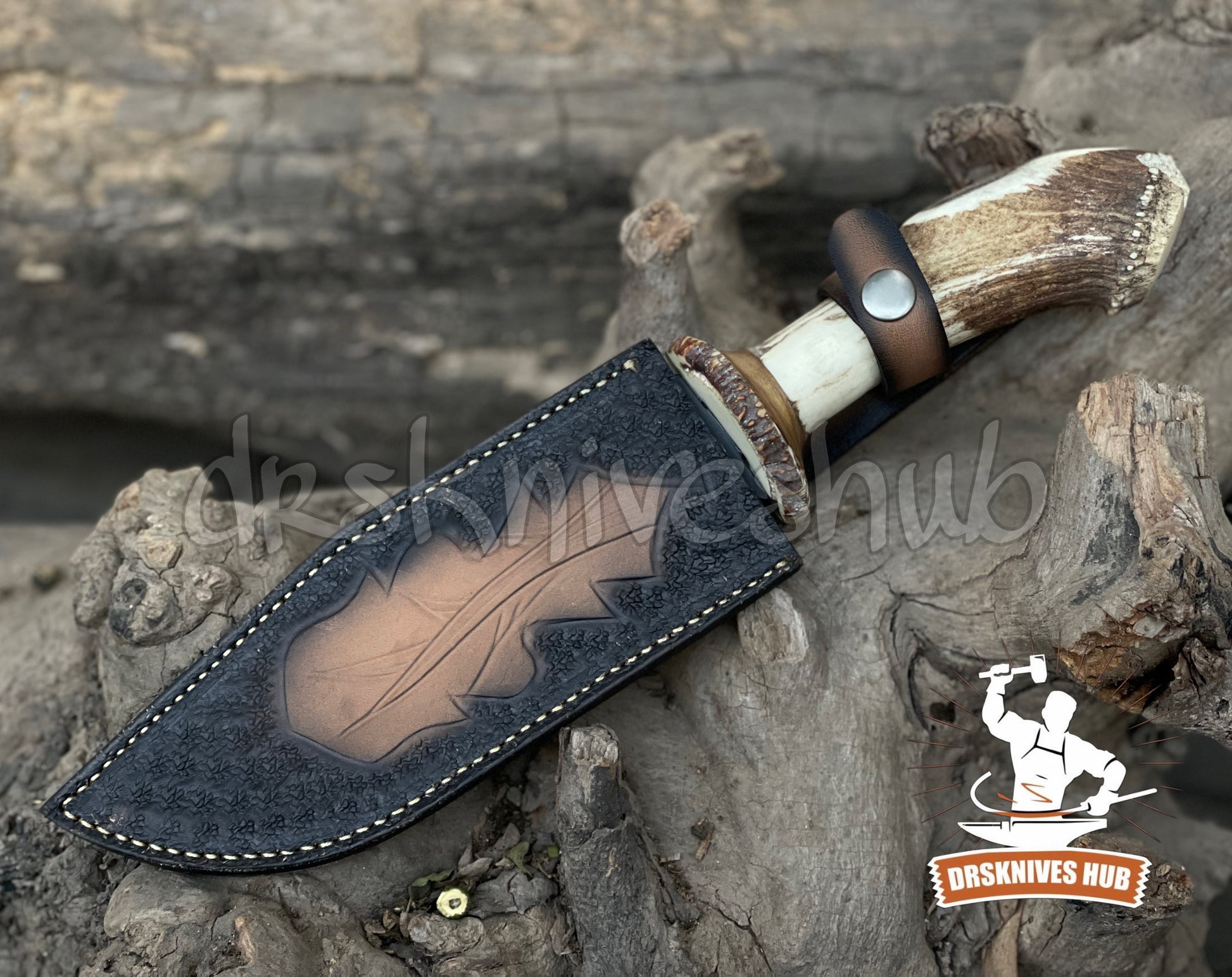 Knife with leather sheath and antler handle on a wooden background, branded 'Bashnives Hub'.