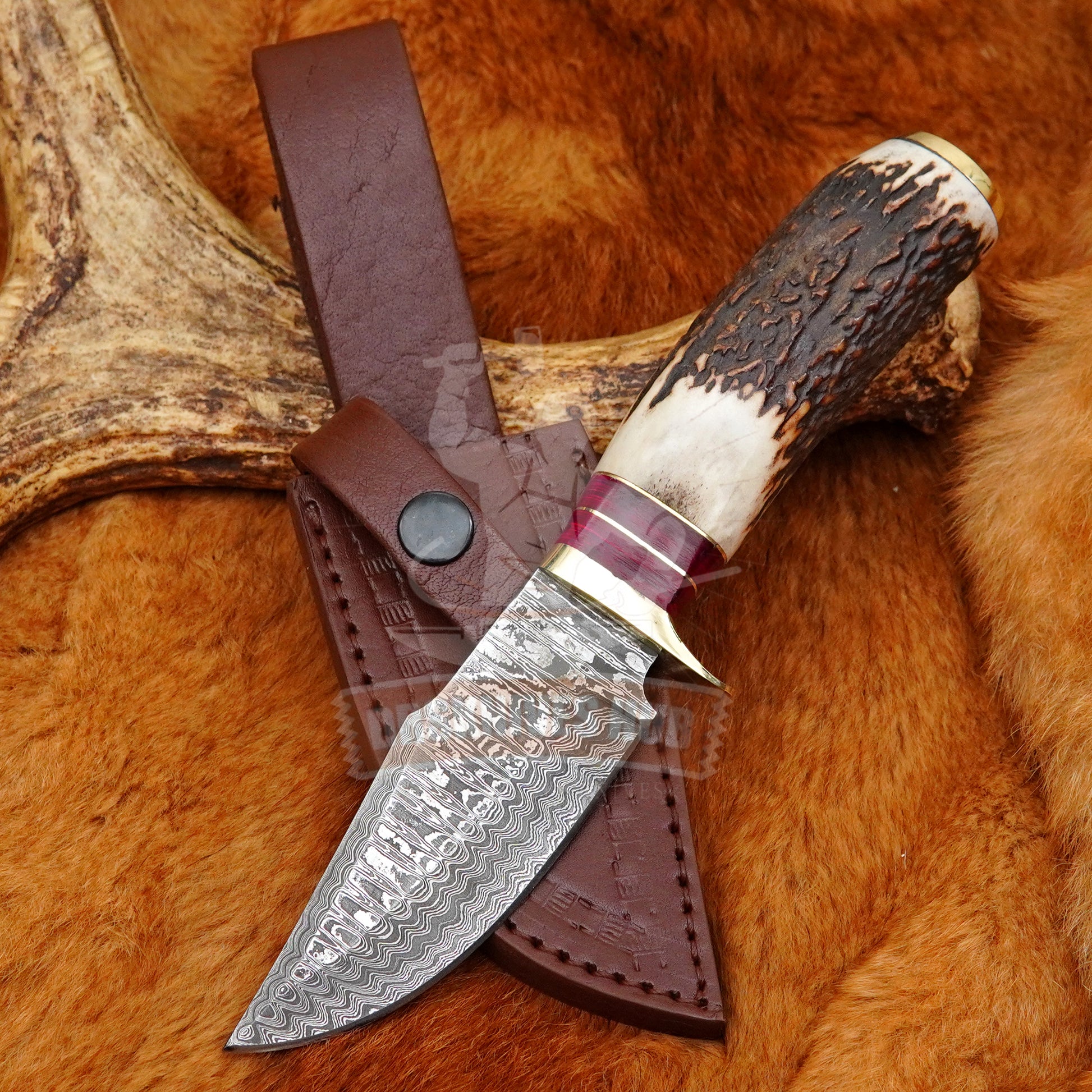Decorative knife with a staghorn handle on a fur background