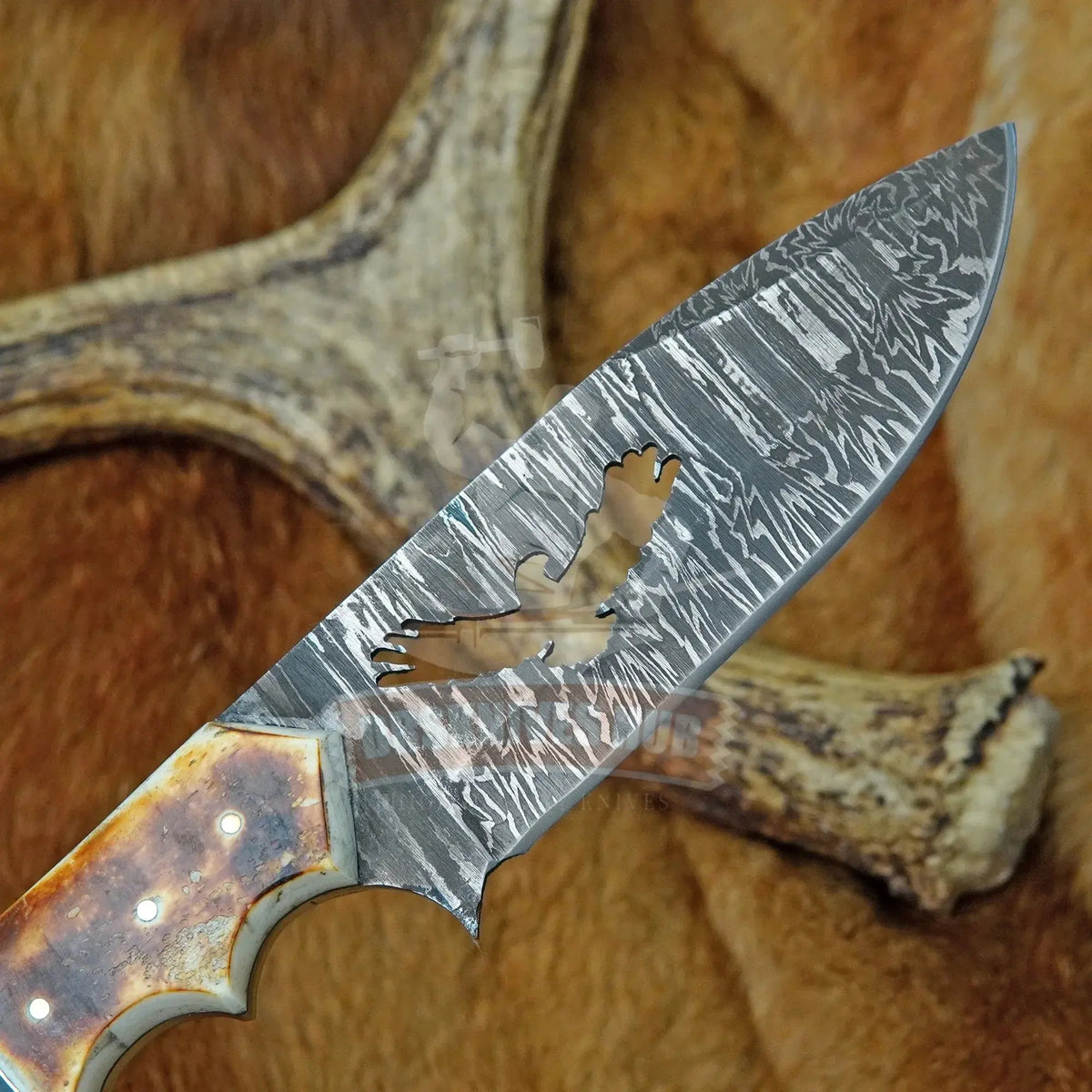 Full-tang Damascus hunting knife with clip-point blade