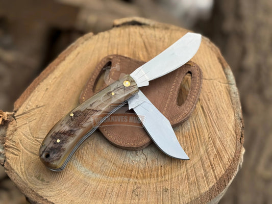 Dual blade folding knife with ram horn handle and leather pouch