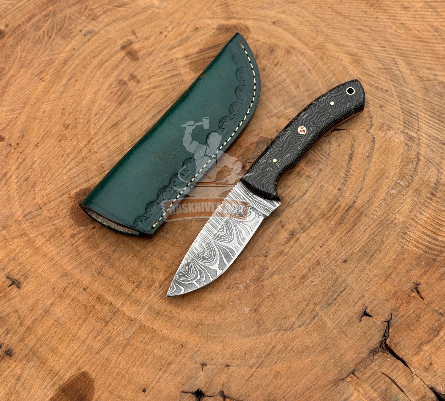 Knife with a green sheath on a wooden surface