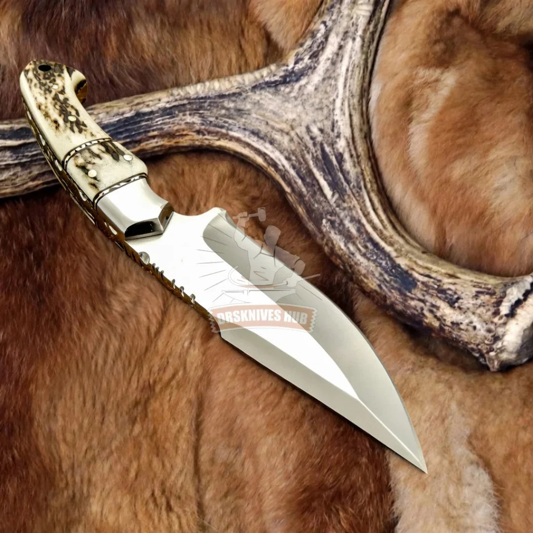 Handmade Damascus knife with exotic bone handle, resting on fur and antler