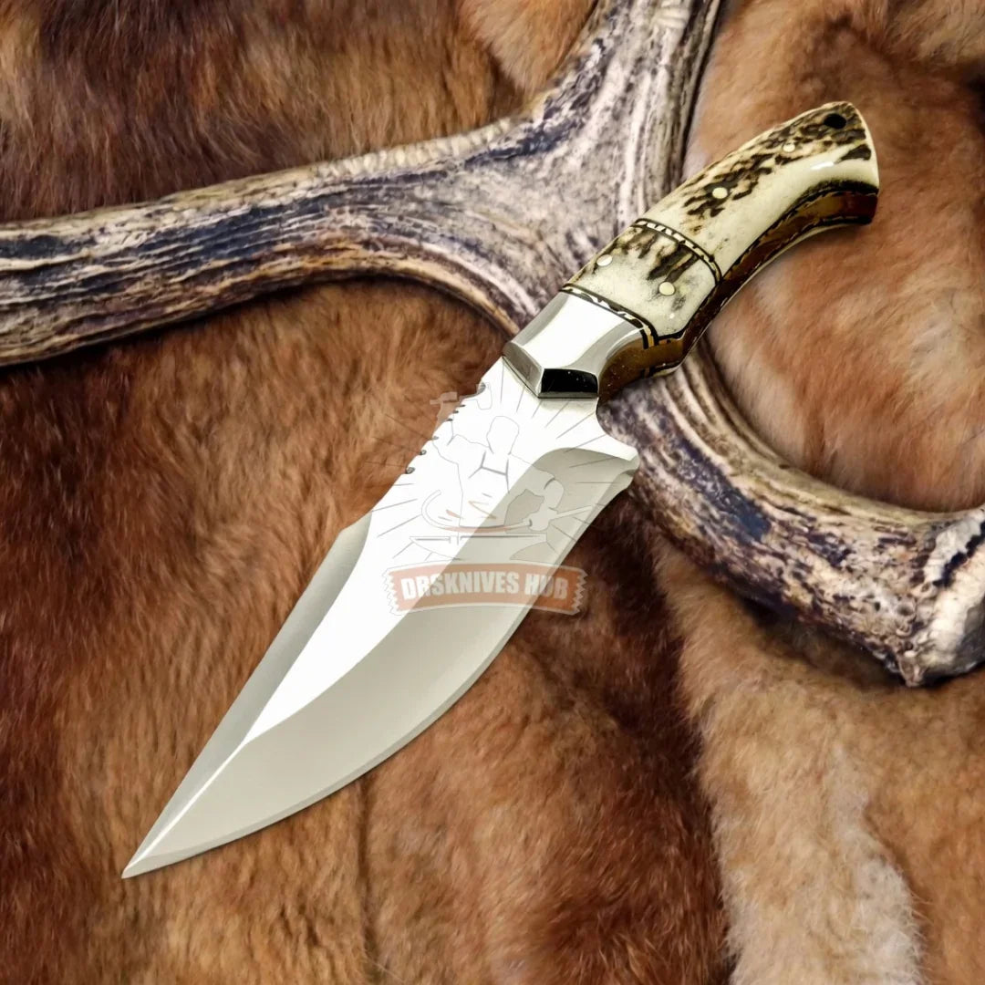 Handmade Damascus hunting knife with bone handle, resting on fur and antler